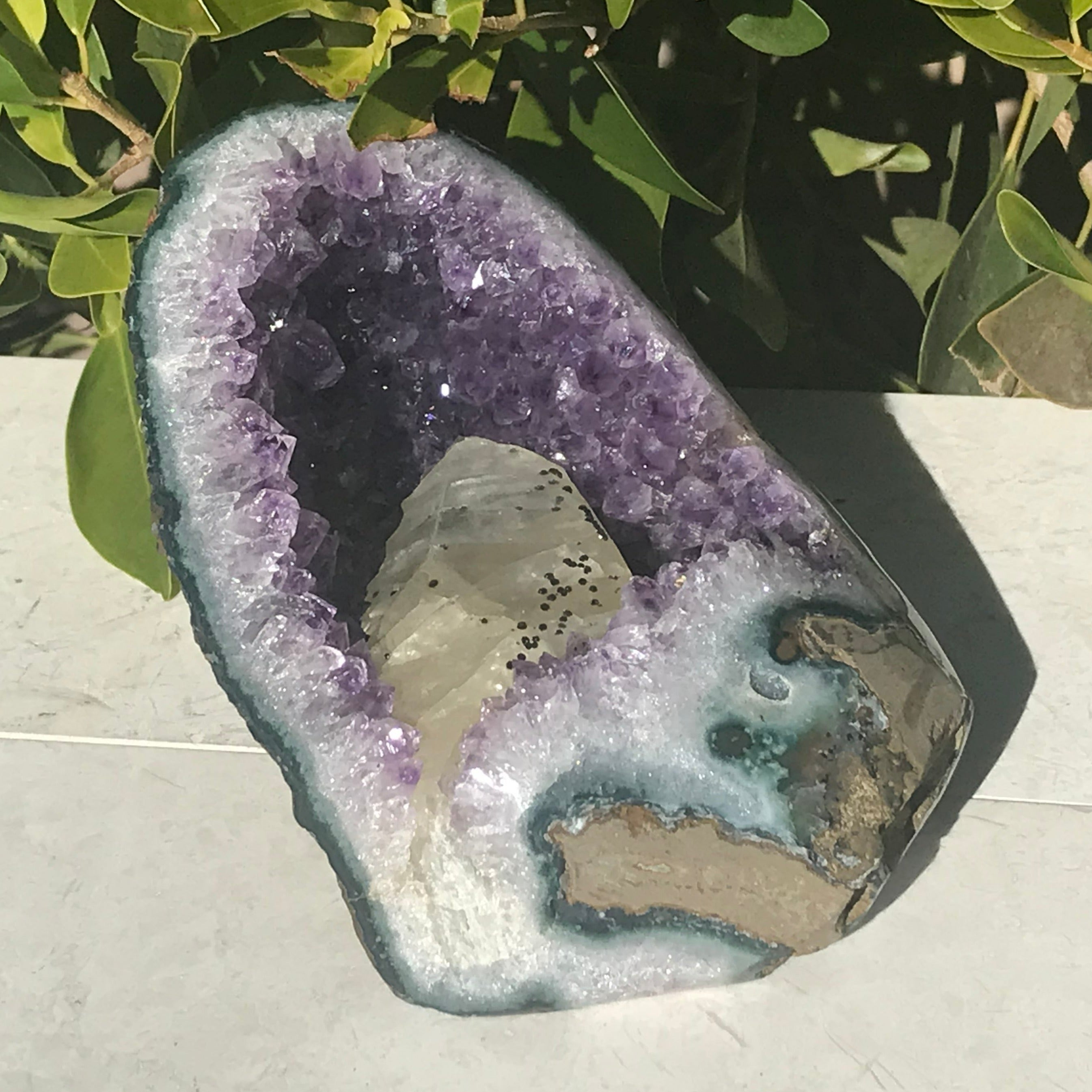Large Calcite in a Small Amethyst Geode
