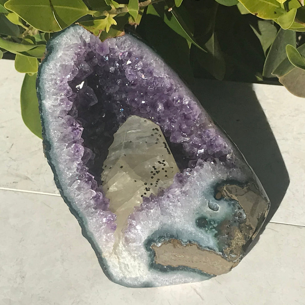 Large Calcite in a Small Amethyst Geode