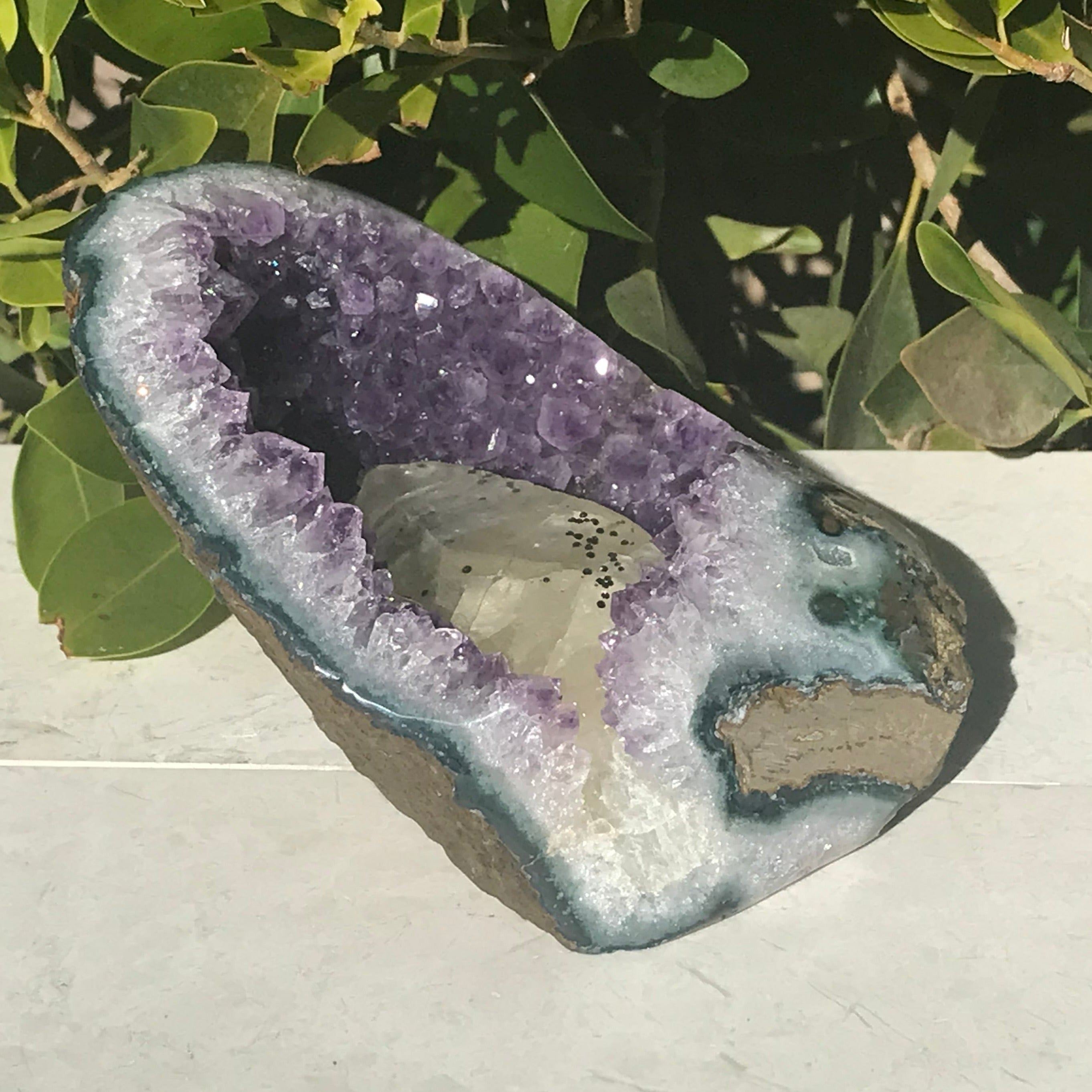 Large Calcite in a Small Amethyst Geode