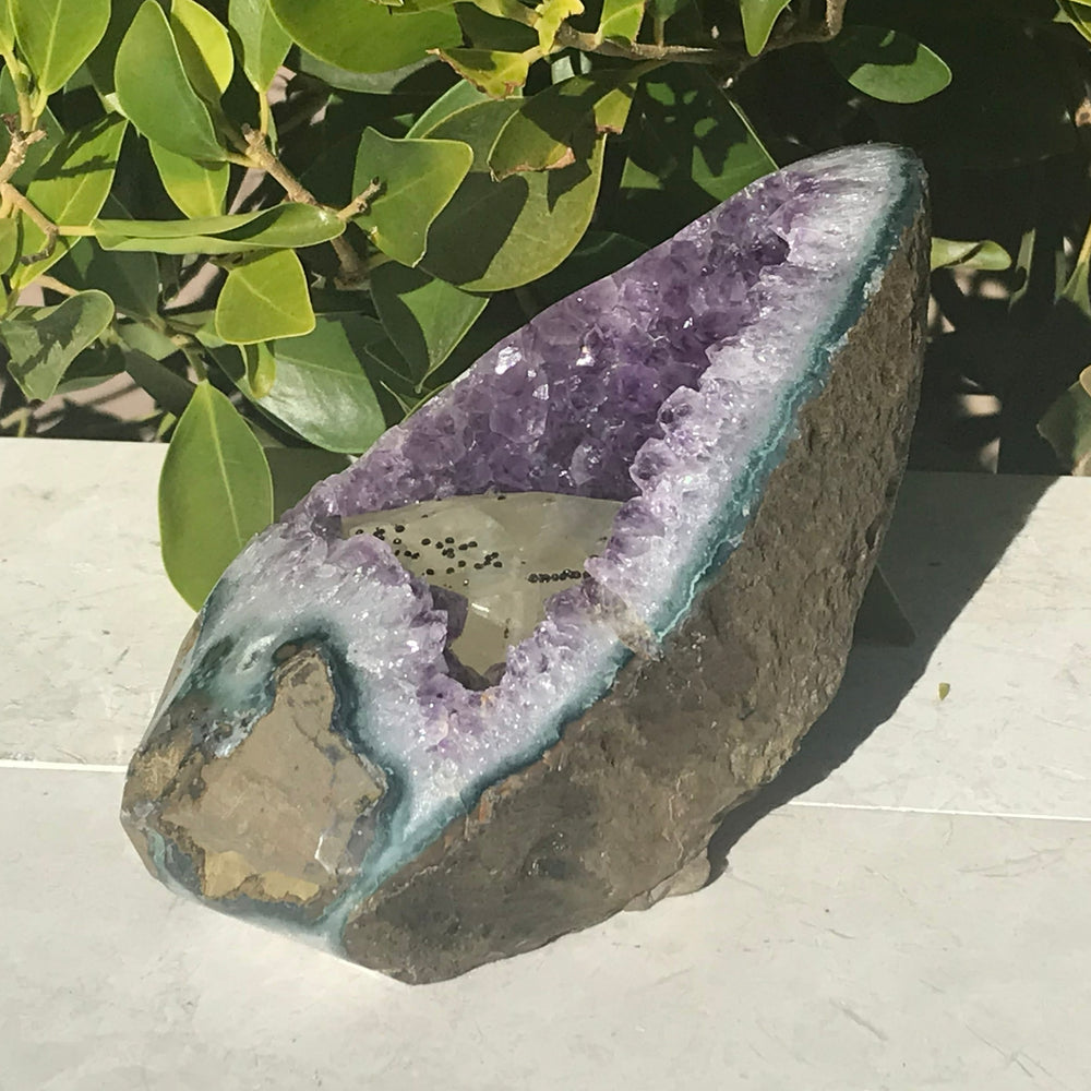 Large Calcite in a Small Amethyst Geode