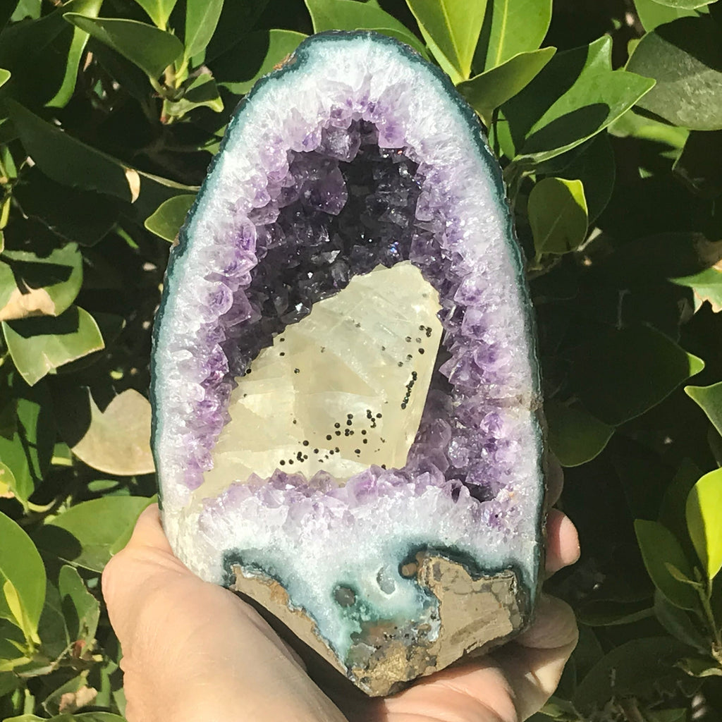 Large Calcite in a Small Amethyst Geode