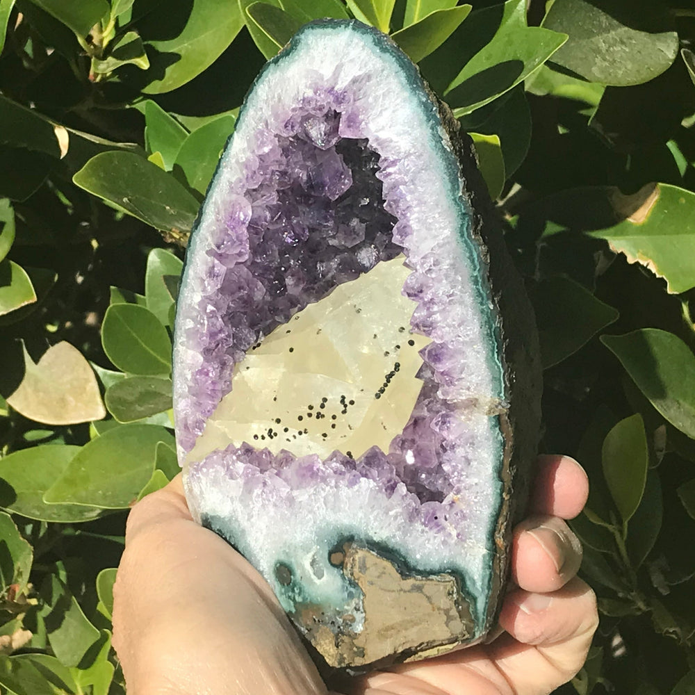 Large Calcite in a Small Amethyst Geode
