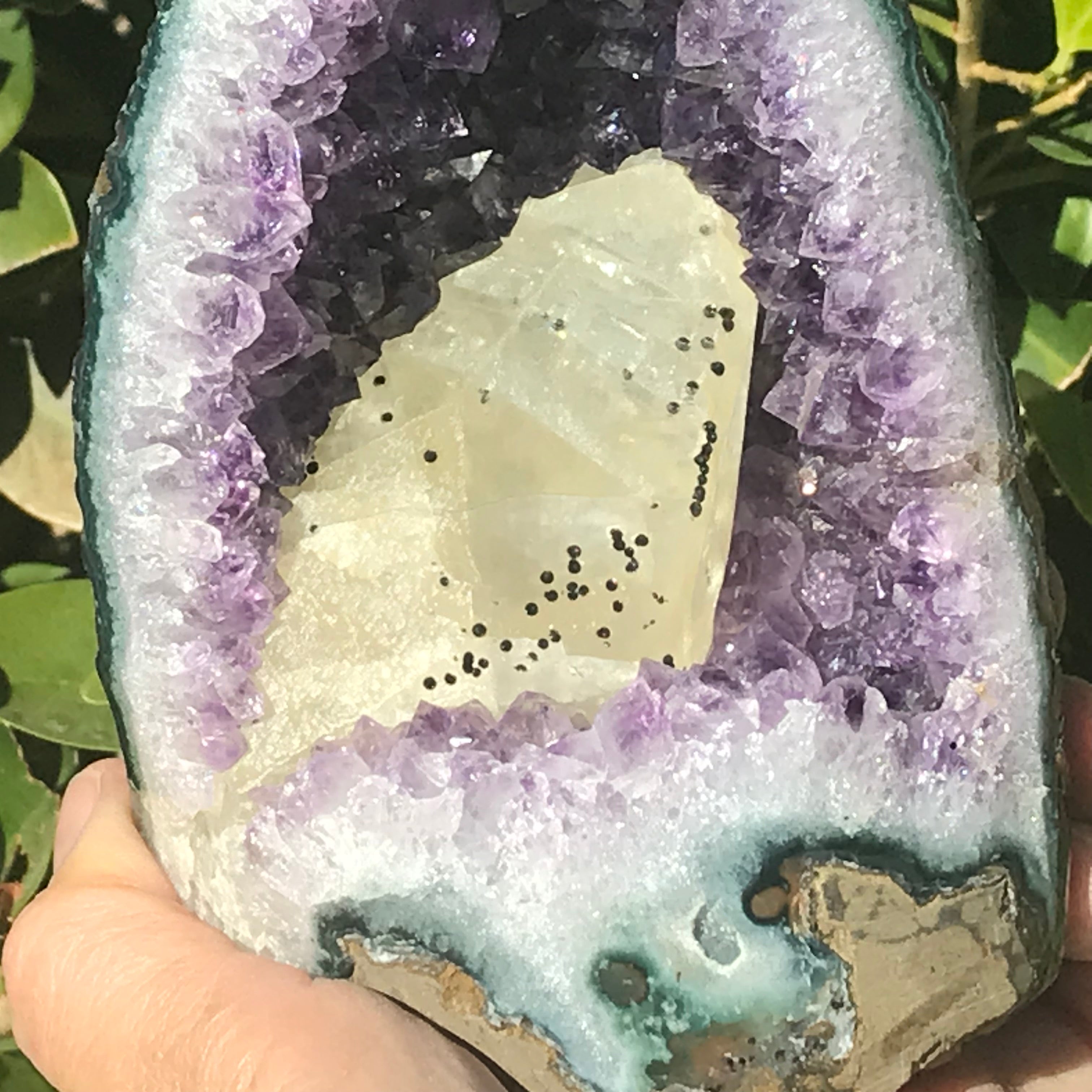 Large Calcite in a Small Amethyst Geode