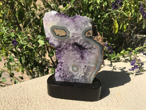 Blue Banded Agate Eyes surrounded by Amethyst Crystals.