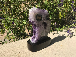 Blue Banded Agate Eyes surrounded by Amethyst Crystals.