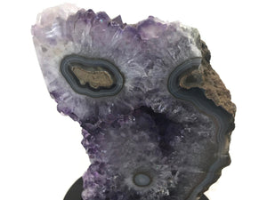 Blue Banded Agate Eyes surrounded by Amethyst Crystals.