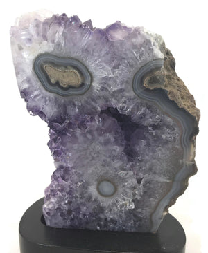 Blue Banded Agate Eyes surrounded by Amethyst Crystals.