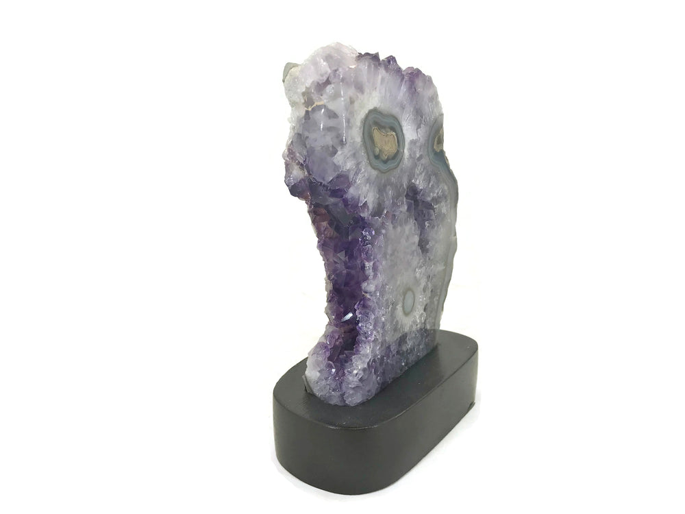 Blue Banded Agate Eyes surrounded by Amethyst Crystals.