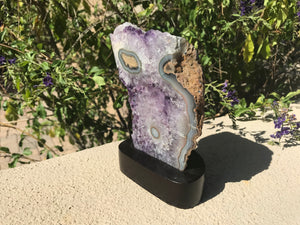 Blue Banded Agate Eyes surrounded by Amethyst Crystals.
